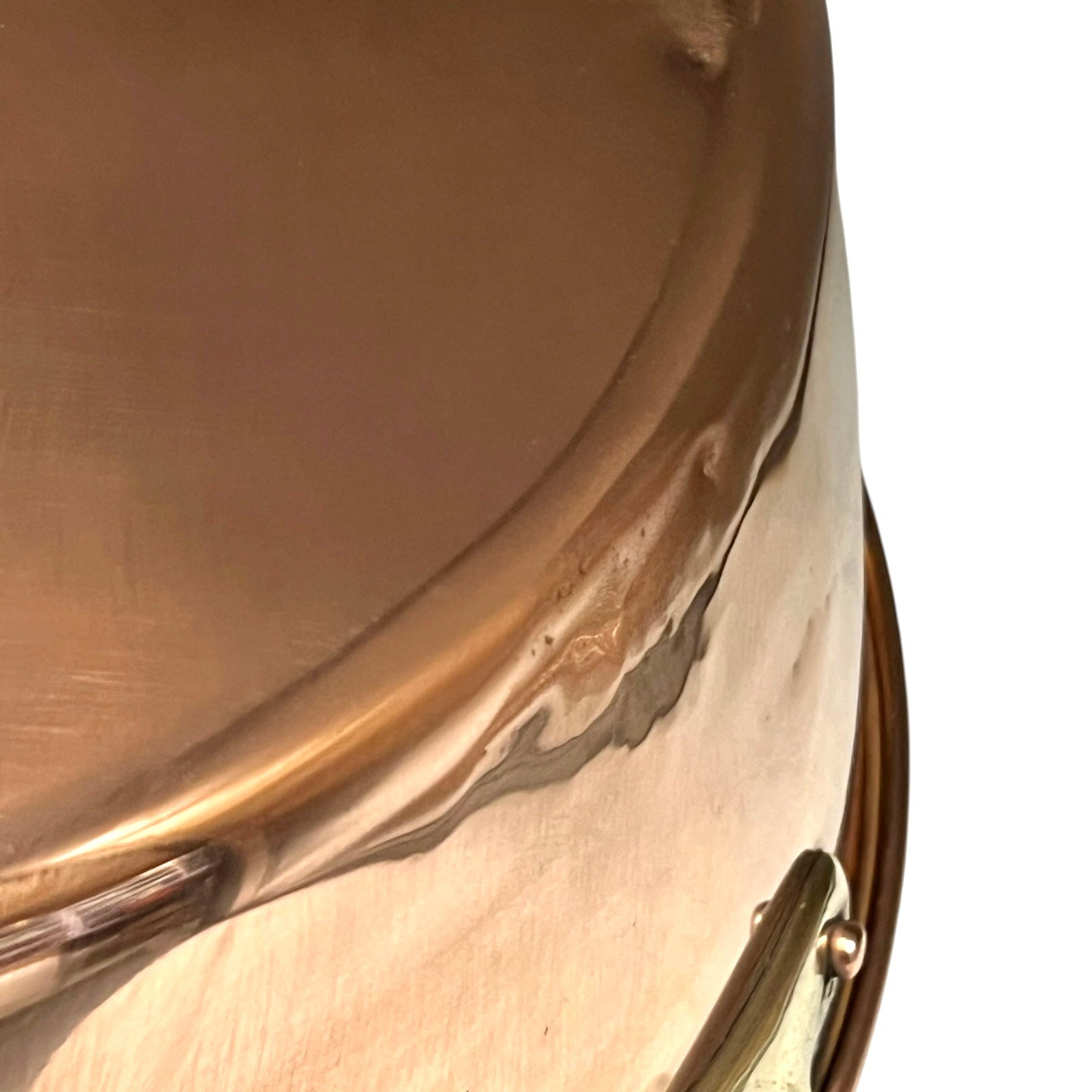 Close-up of a copper up cycled sink with brass handles on a white background.