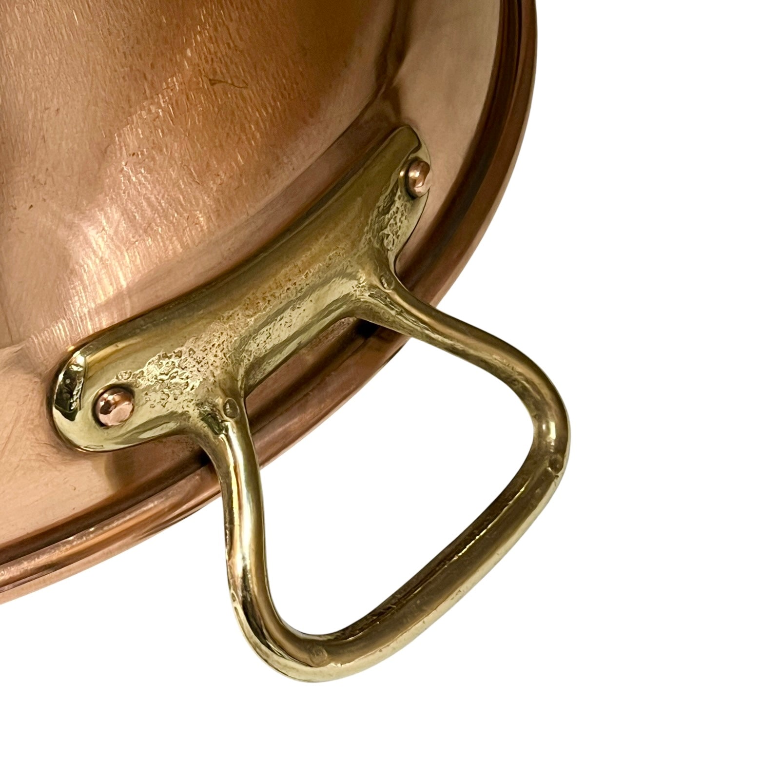 Close-up of a copper sink with a drain plug
