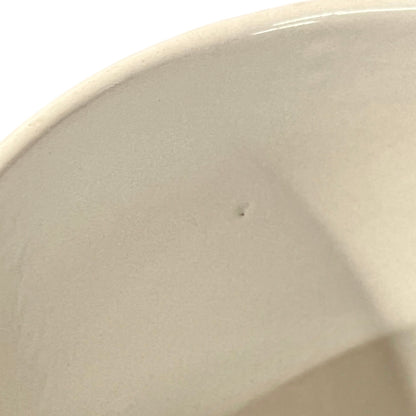 Close up of a fondue pan on a white background