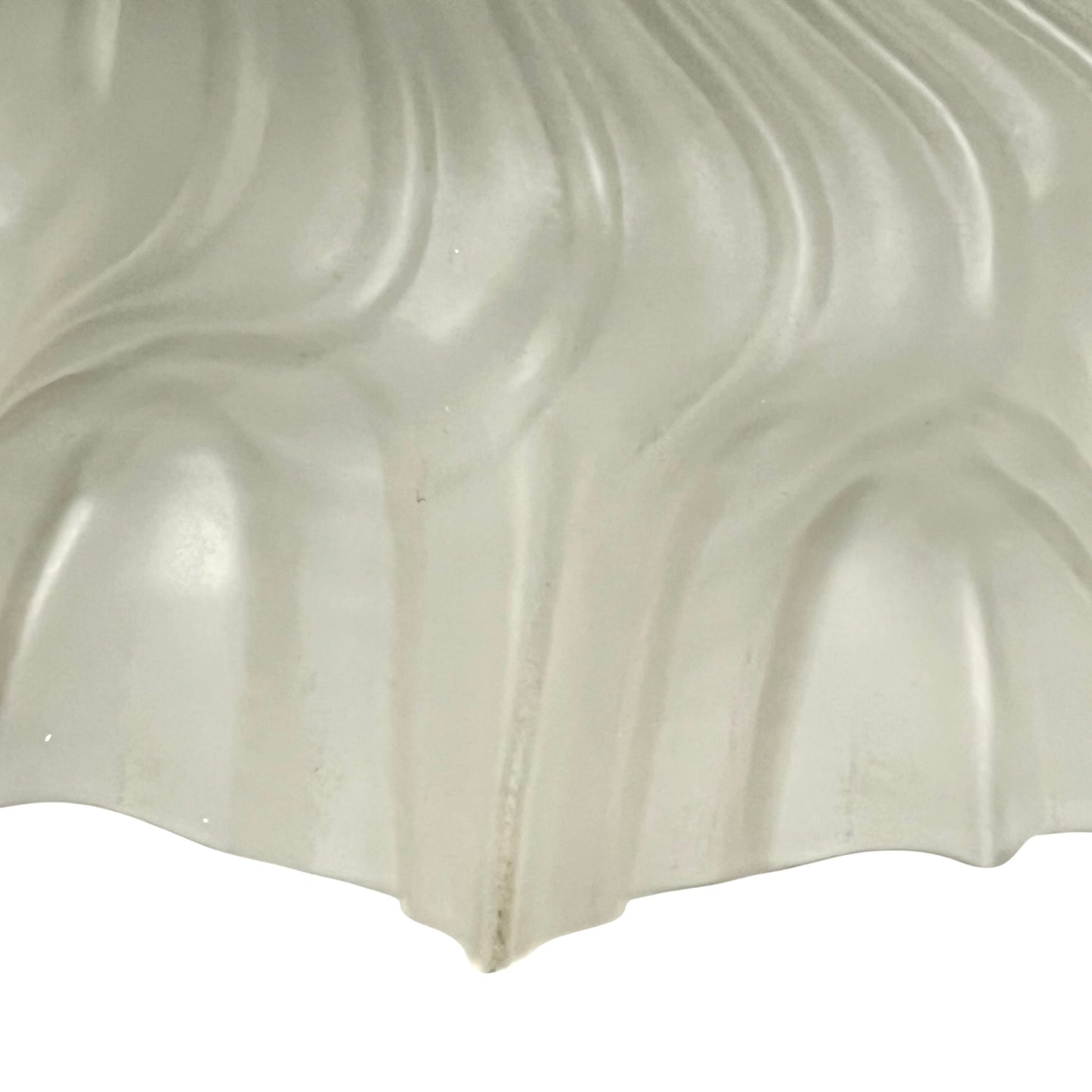 Close up of a glass lampshade on a white background 