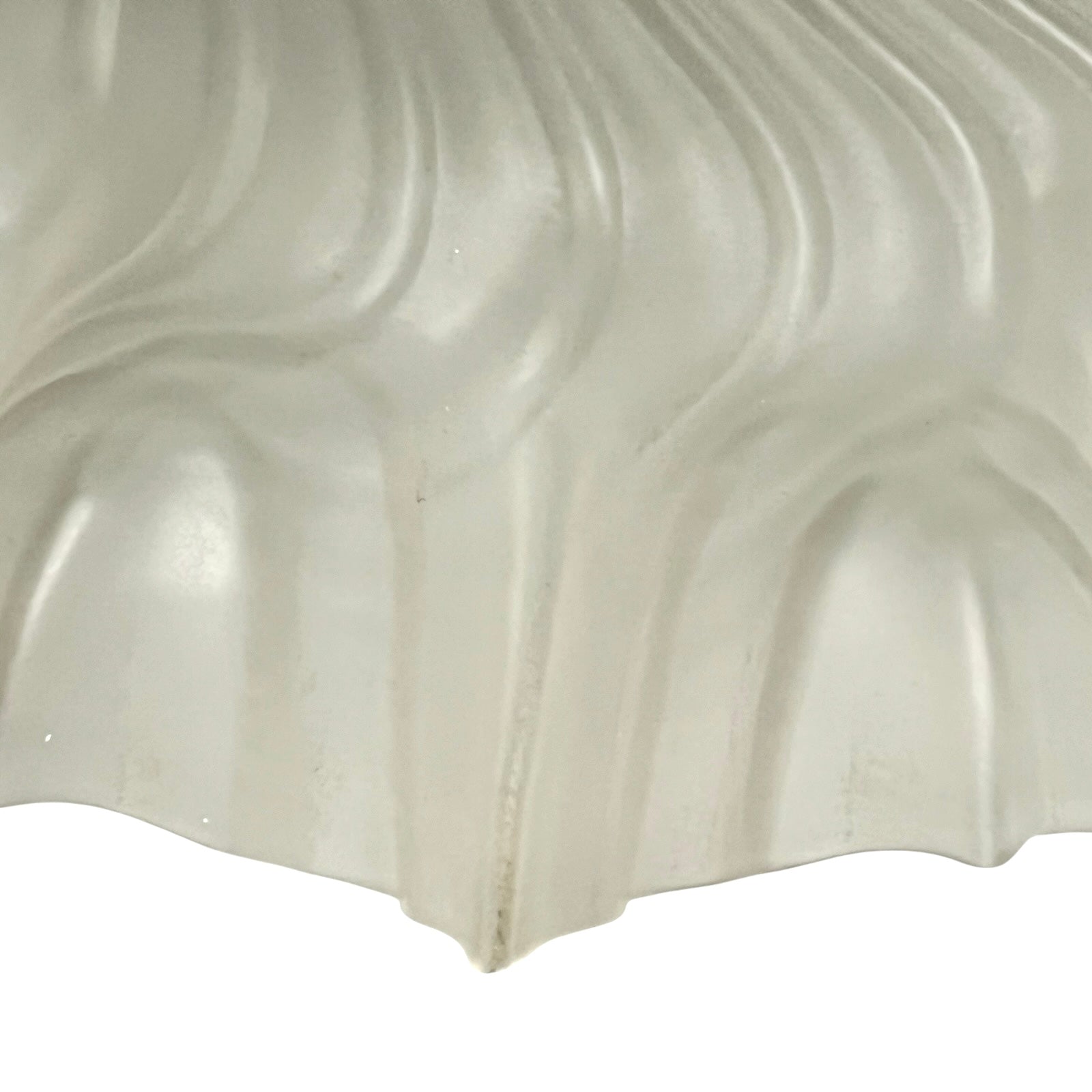 Close up of a glass lampshade on a white background 