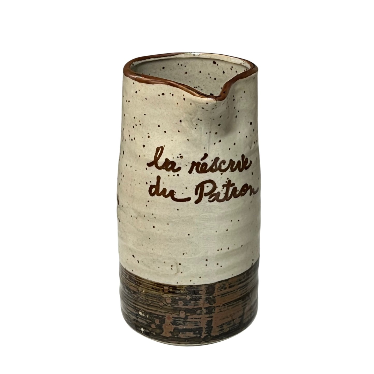 Ceramic speckled brown and cream vase with French text on a white background