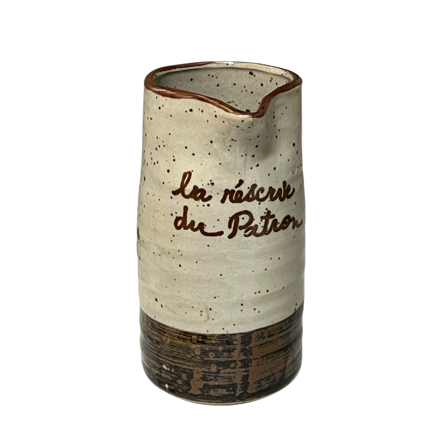 Ceramic speckled brown and cream vase with French text on a white background