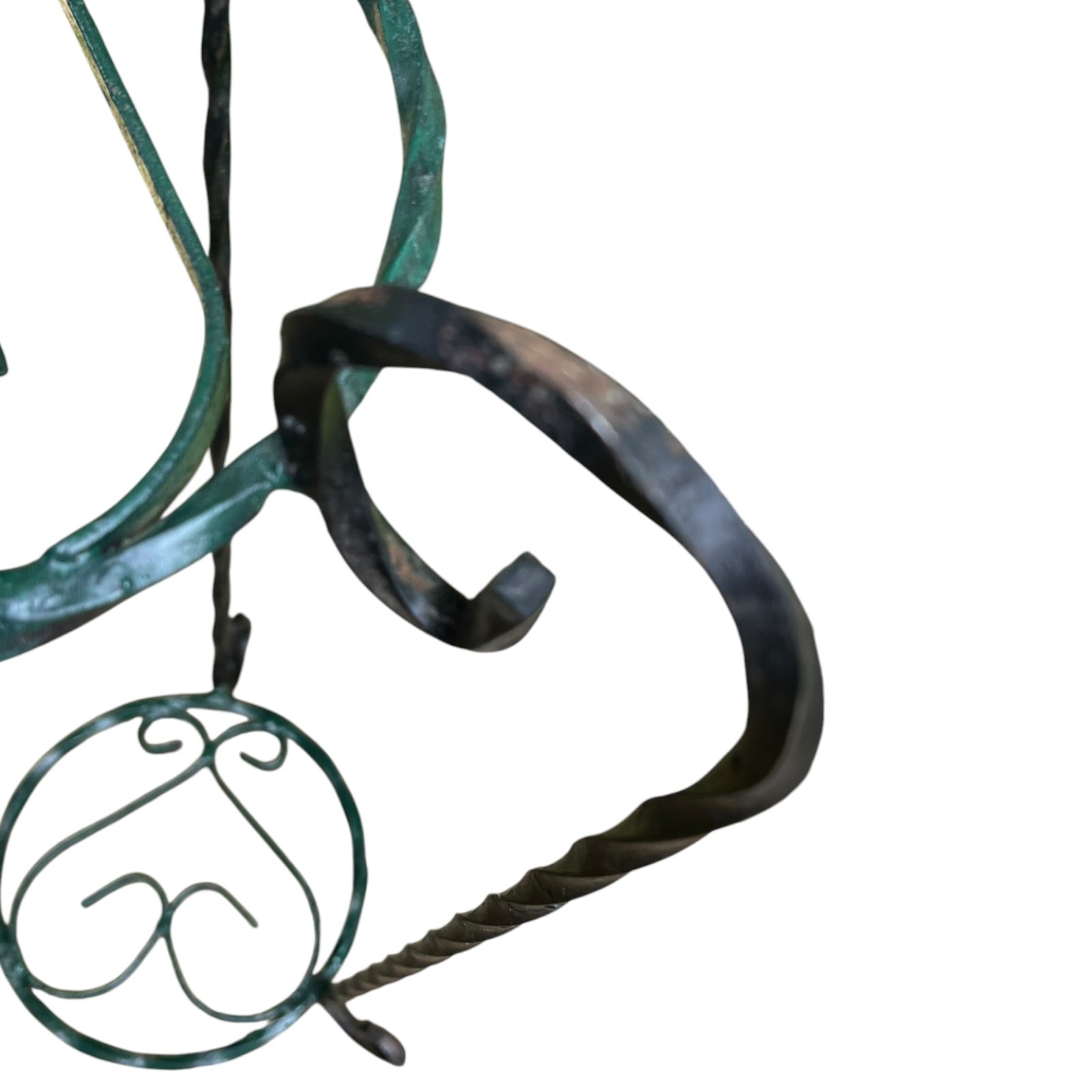Close up of a wrought iron vintage plant stand on a white background 