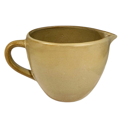 Back view of ceramic pitcher on a white background