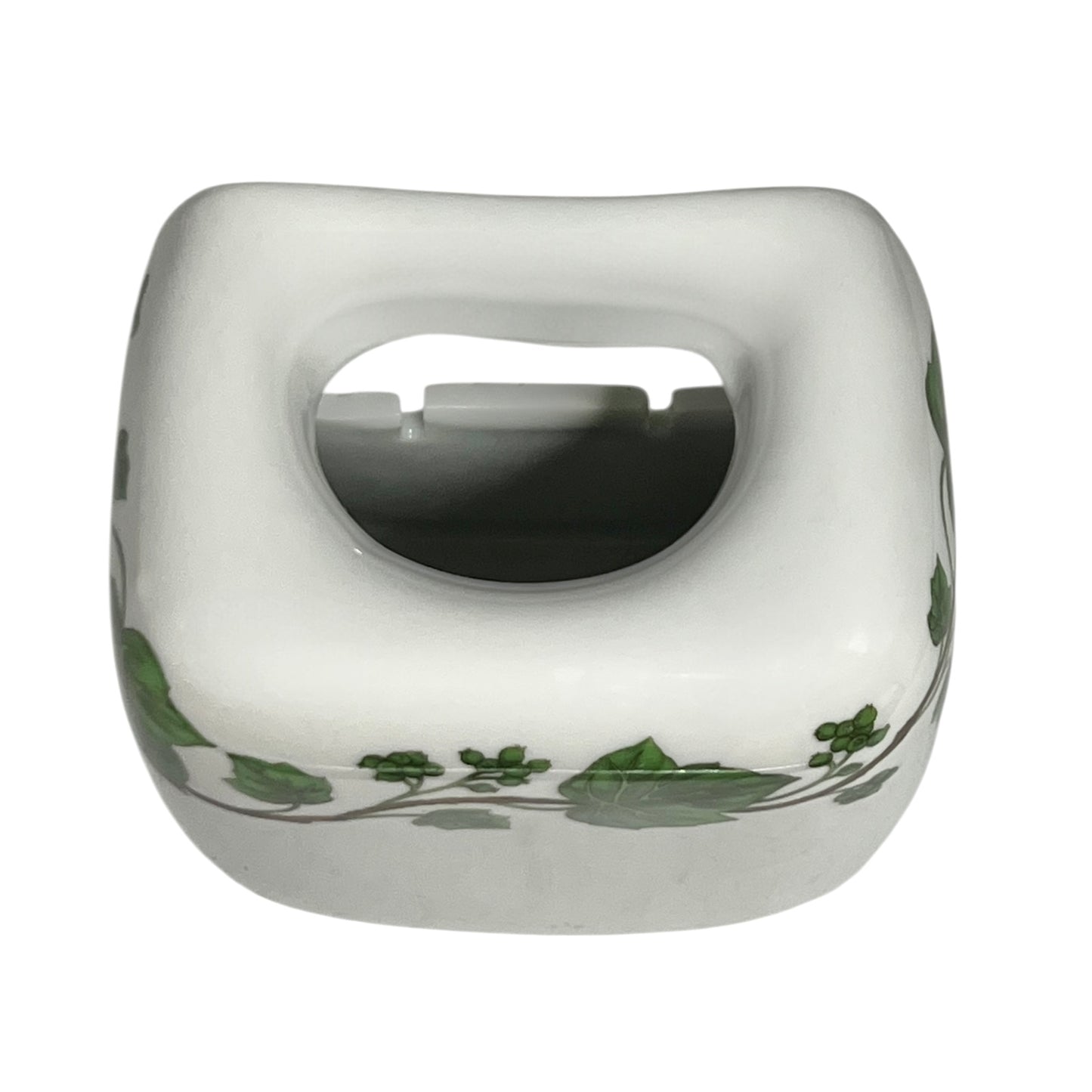 White ceramic pot with green leaf patterns on a white background