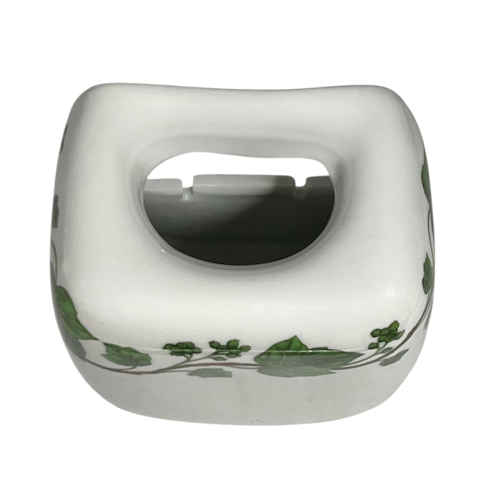 White ceramic pot with green leaf patterns on a white background