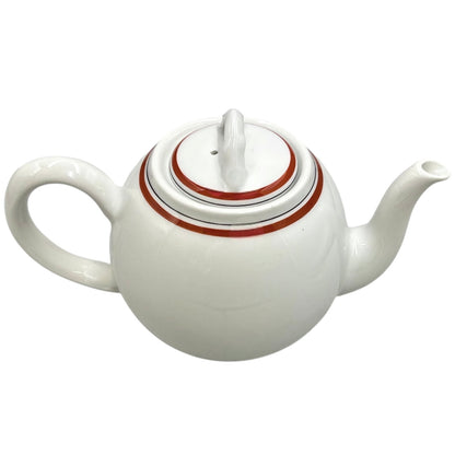 White ceramic teapot with a red stripe on a white background