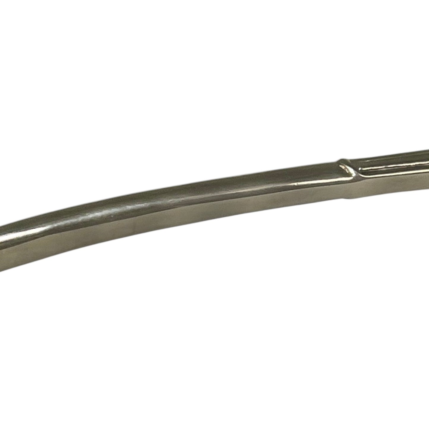 close up of a decorative Christmas tree shaped silver candle snuffer on a white background