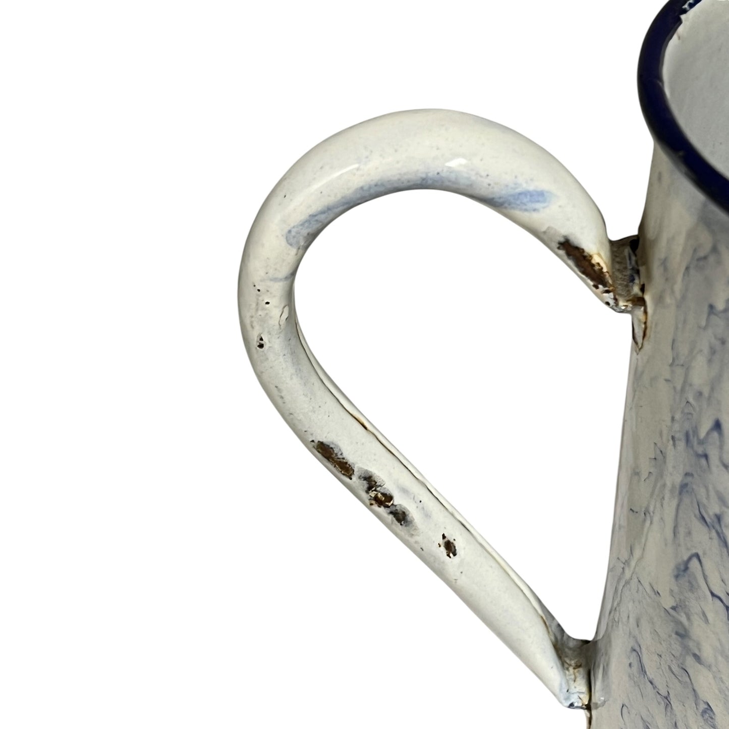 Close-up of a distressed enamel mug handle and upper body, featuring a white enamel finish with blue marbled swirls and dark brown rust-like chipped details, on a plain white background.