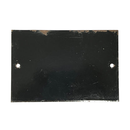 A rectangular black metal plate with two pre-drilled holes on the left and right sides, showing signs of wear and rust along the top edge, set against a plain white background.