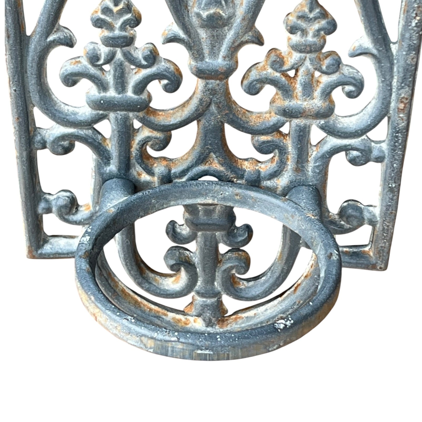 close up of a metal decorative wall planter on a white background