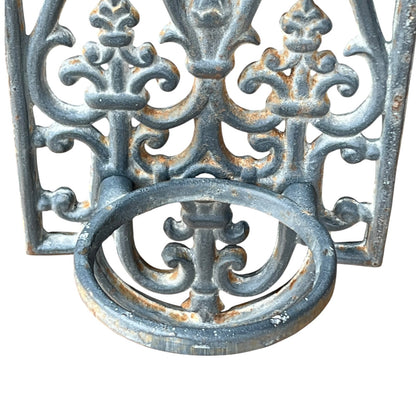 close up of a metal decorative wall planter on a white background