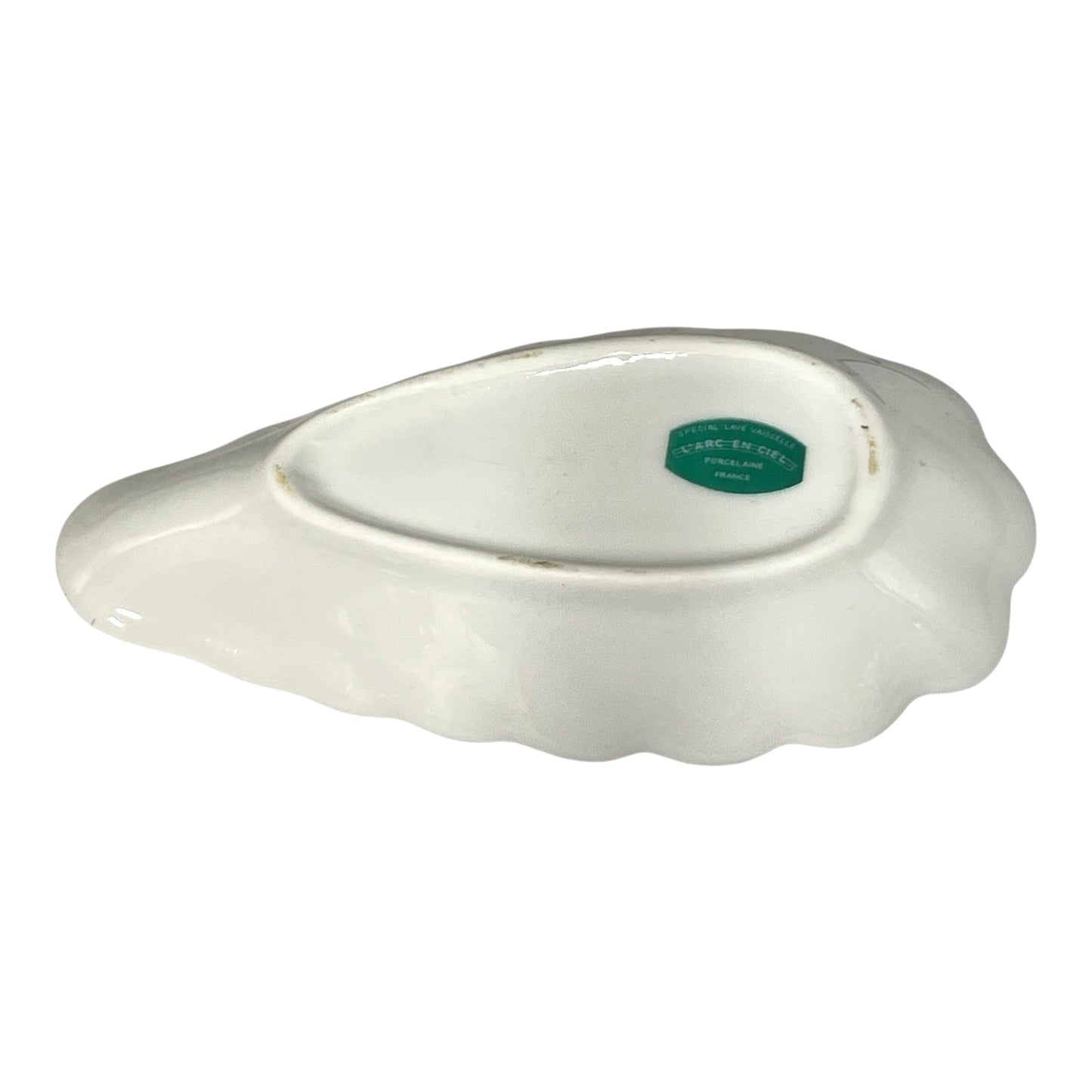 White ceramic dish with a green label on a white background