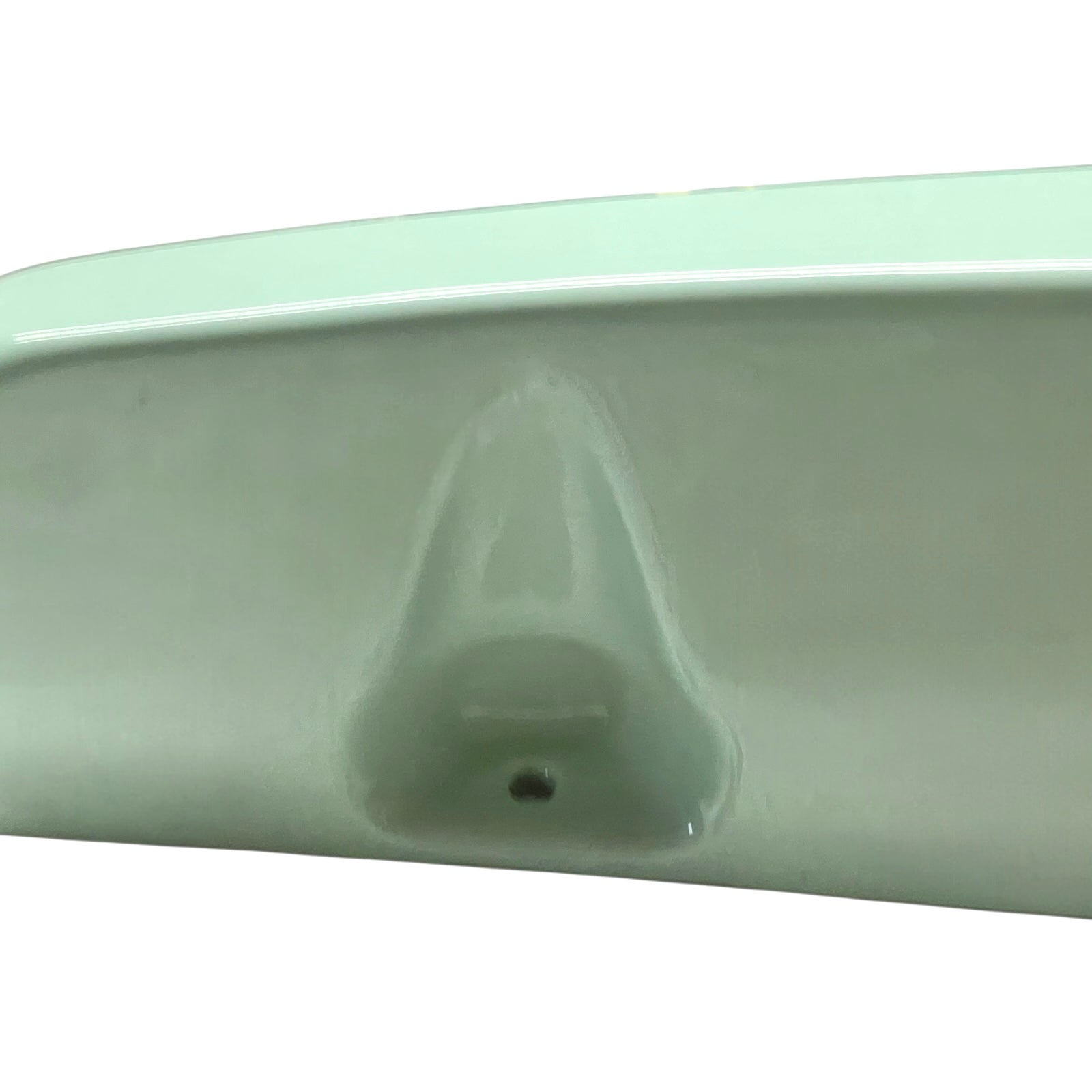 close up of pale green ceramic shelf on a white background
