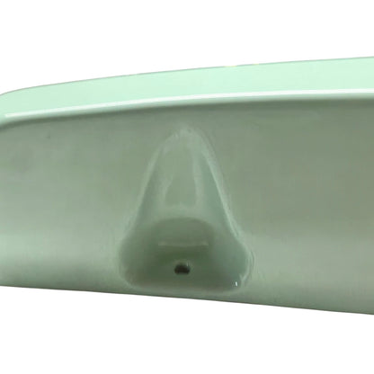 close up of pale green ceramic shelf on a white background