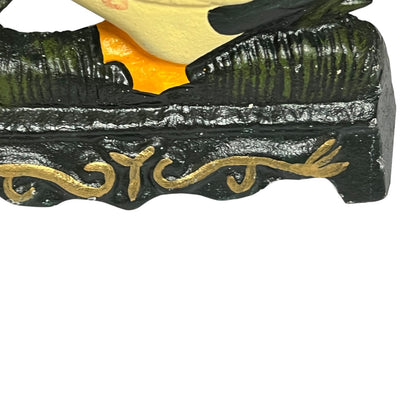 Close-up of a decorative door stop showing part of a yellow and black bird perched on a dark green textured branch with gold scrollwork, isolated on a white background.