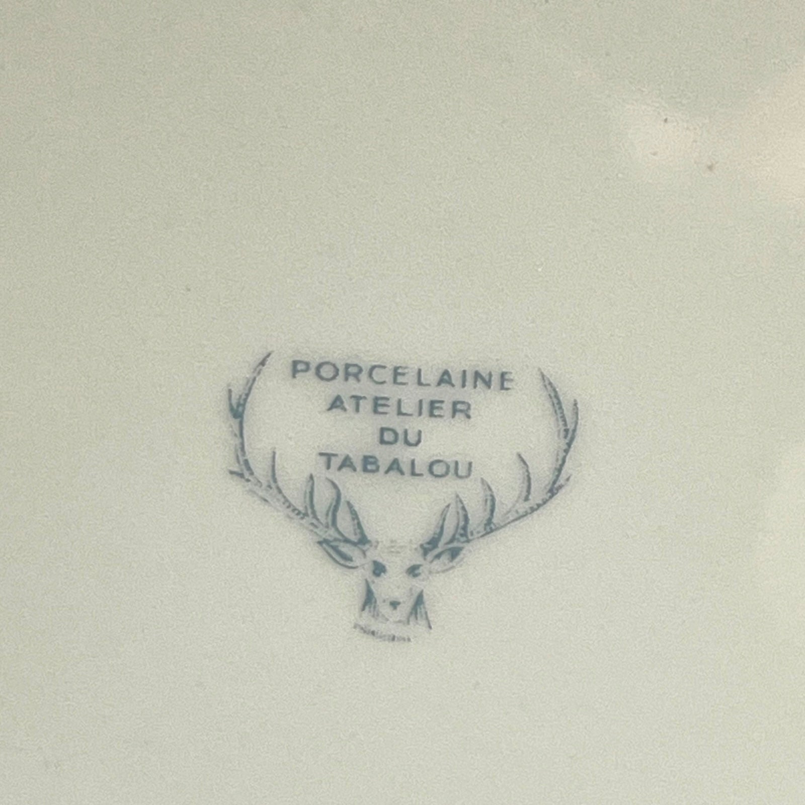 Porcelain mark with deer head design and text on the back of a plate