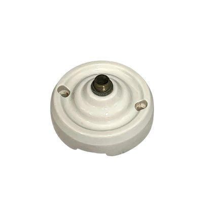 Small vintage French porcelain ceiling rose with a brass nut on a white background 