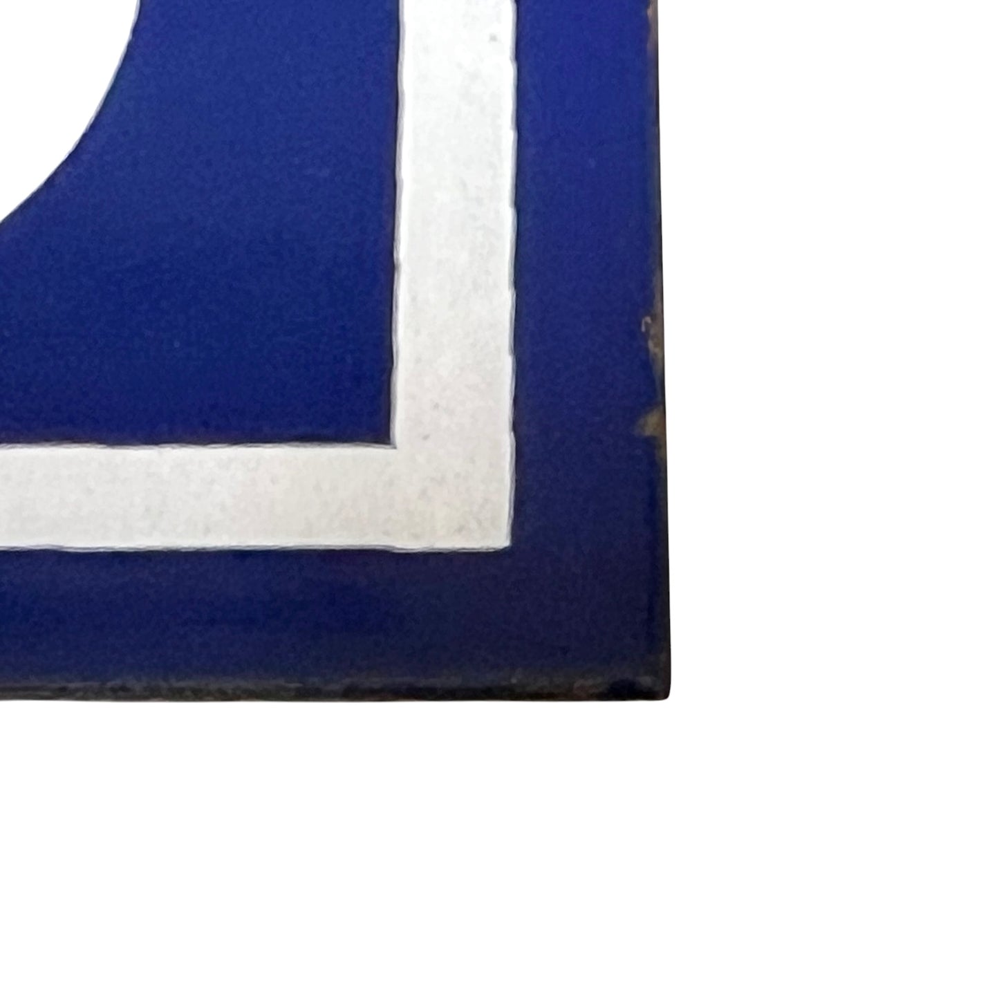 Close up of blue and white door number 65 on a white background 