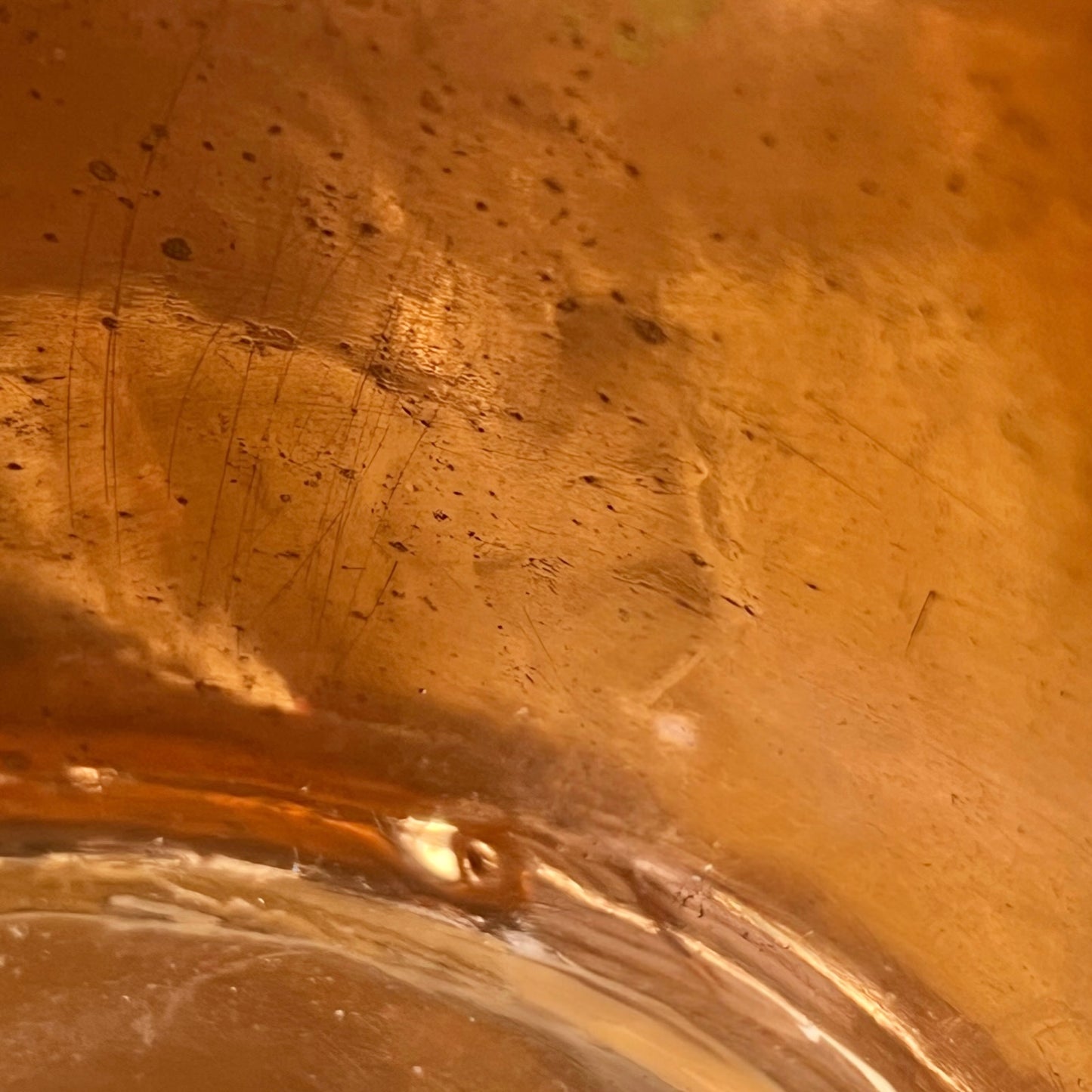 Close-up of a copper pot with a pouring spout on a white background