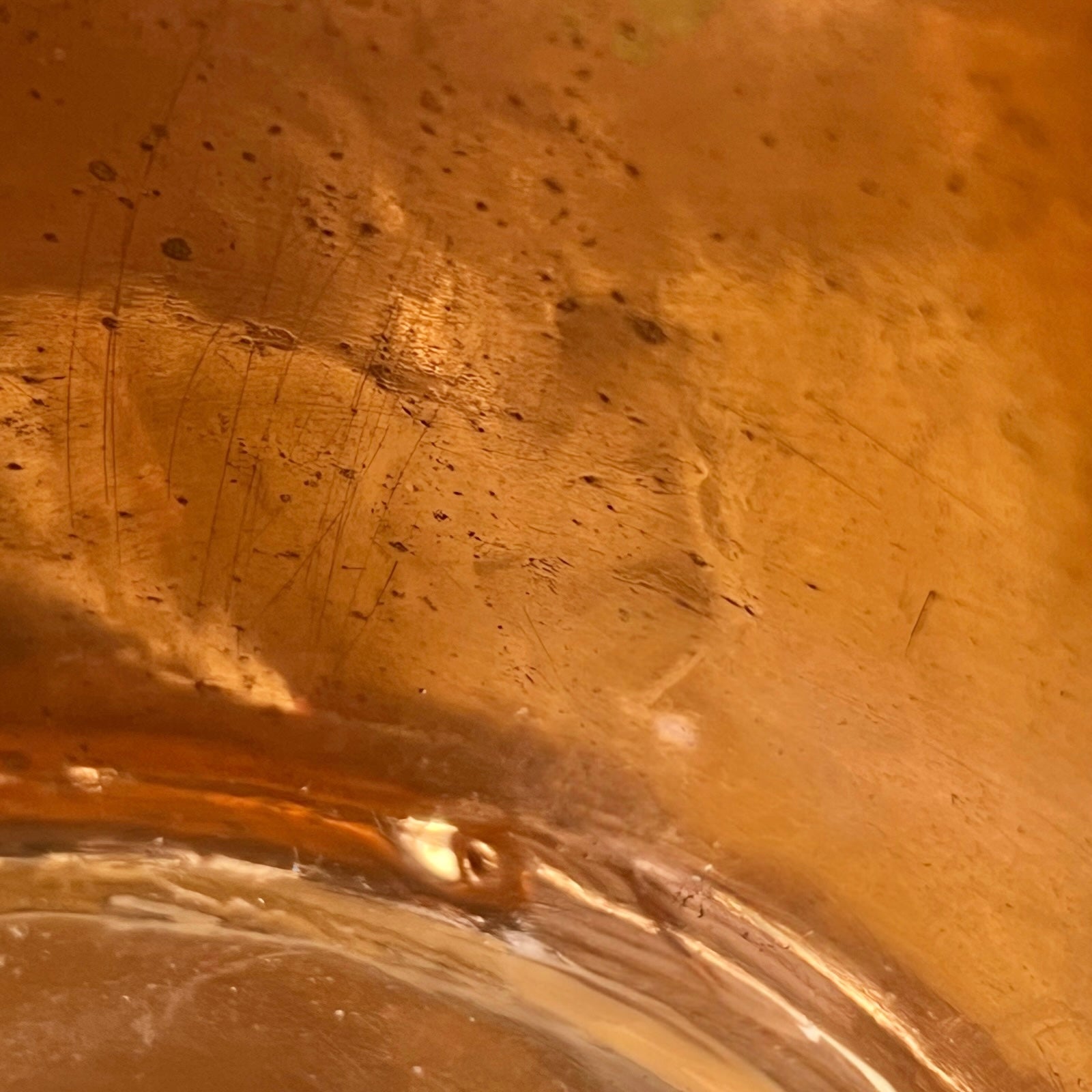 Close-up of a copper pot with a pouring spout on a white background