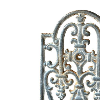 close up of a metal decorative wall planter on a white background
