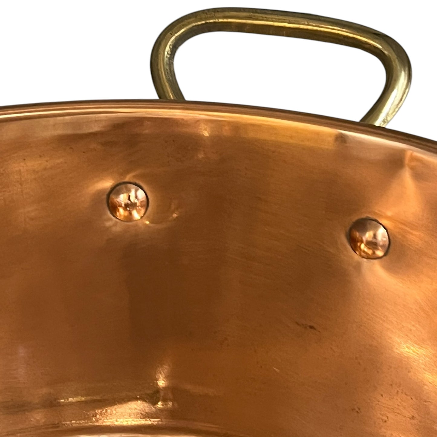 Close-up of a copper sink with a drain plug on a white background