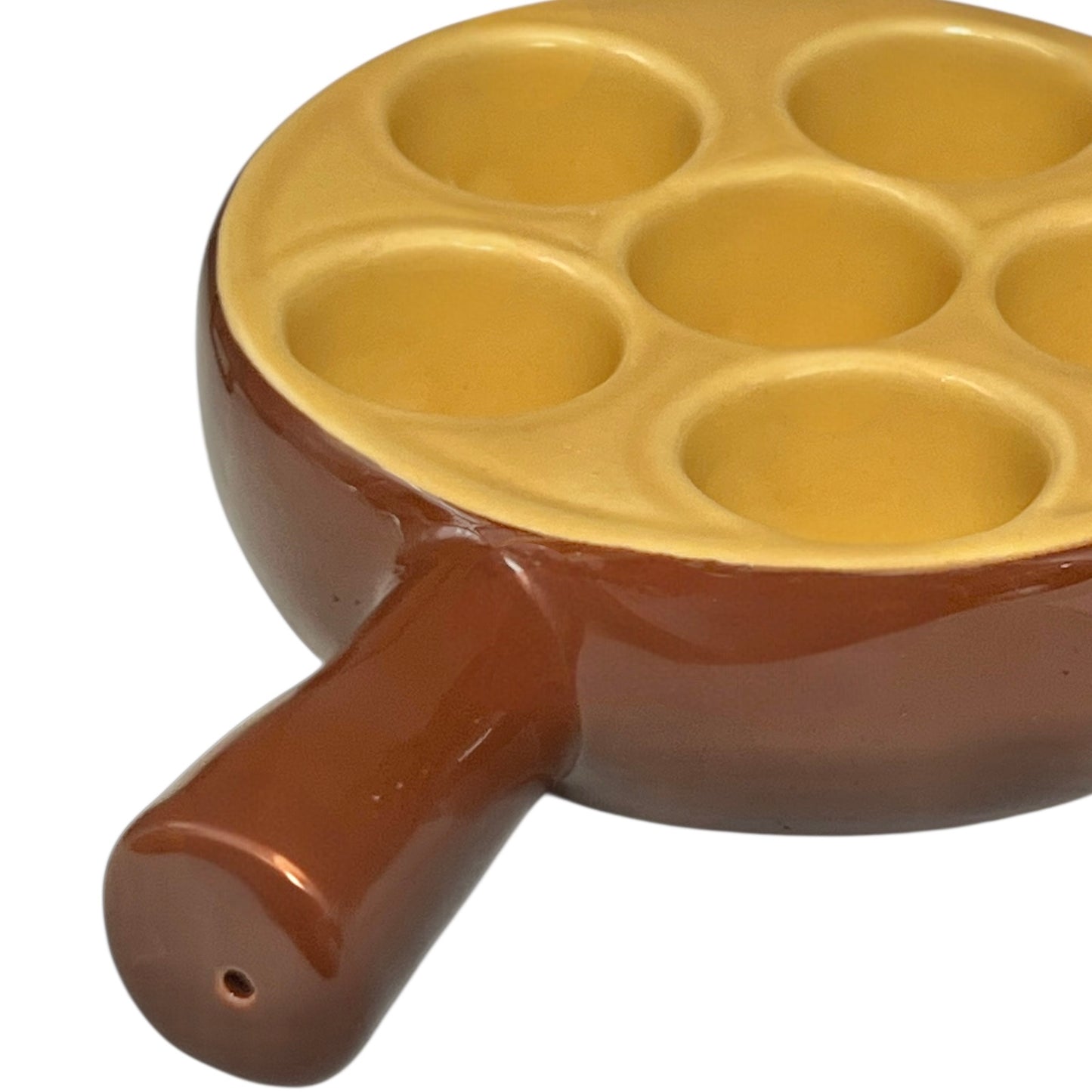 brown ceramic escargots dish with handles and a pale interior, on a white background.