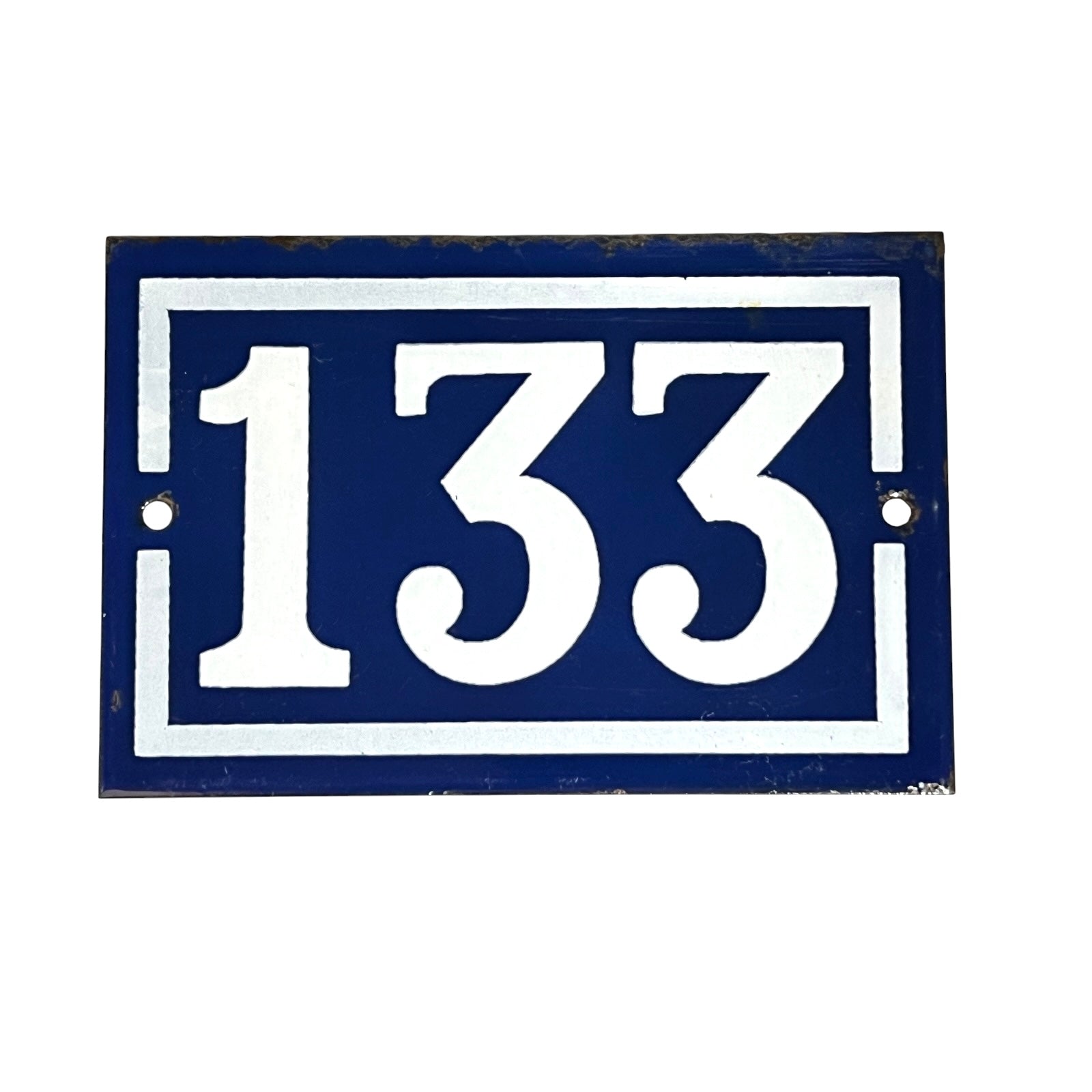 A rectangular blue house number plaque featuring the white numbers '133' in a bold serif font, bordered by a white double-line frame. The plaque has a distressed, vintage look with minor wear and rust spots, and is shown against a plain white background.