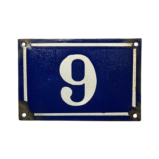 A vintage-style rectangular house number plaque featuring the number '9' in white on a dark blue background, with a white border and distressed metal corners, shown against a plain white background.