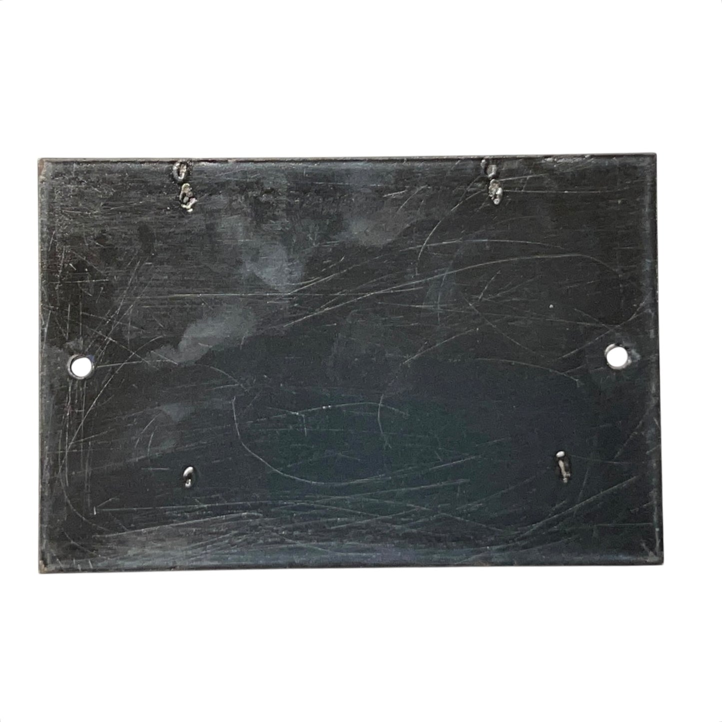 Scratched black rectangular plate on a white background