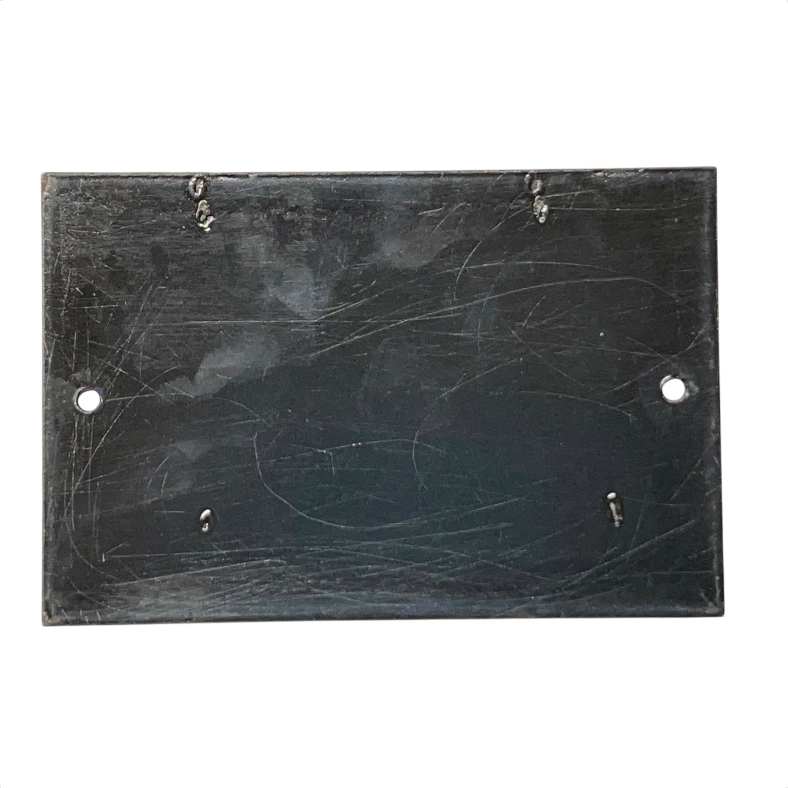 Scratched black rectangular plate on a white background