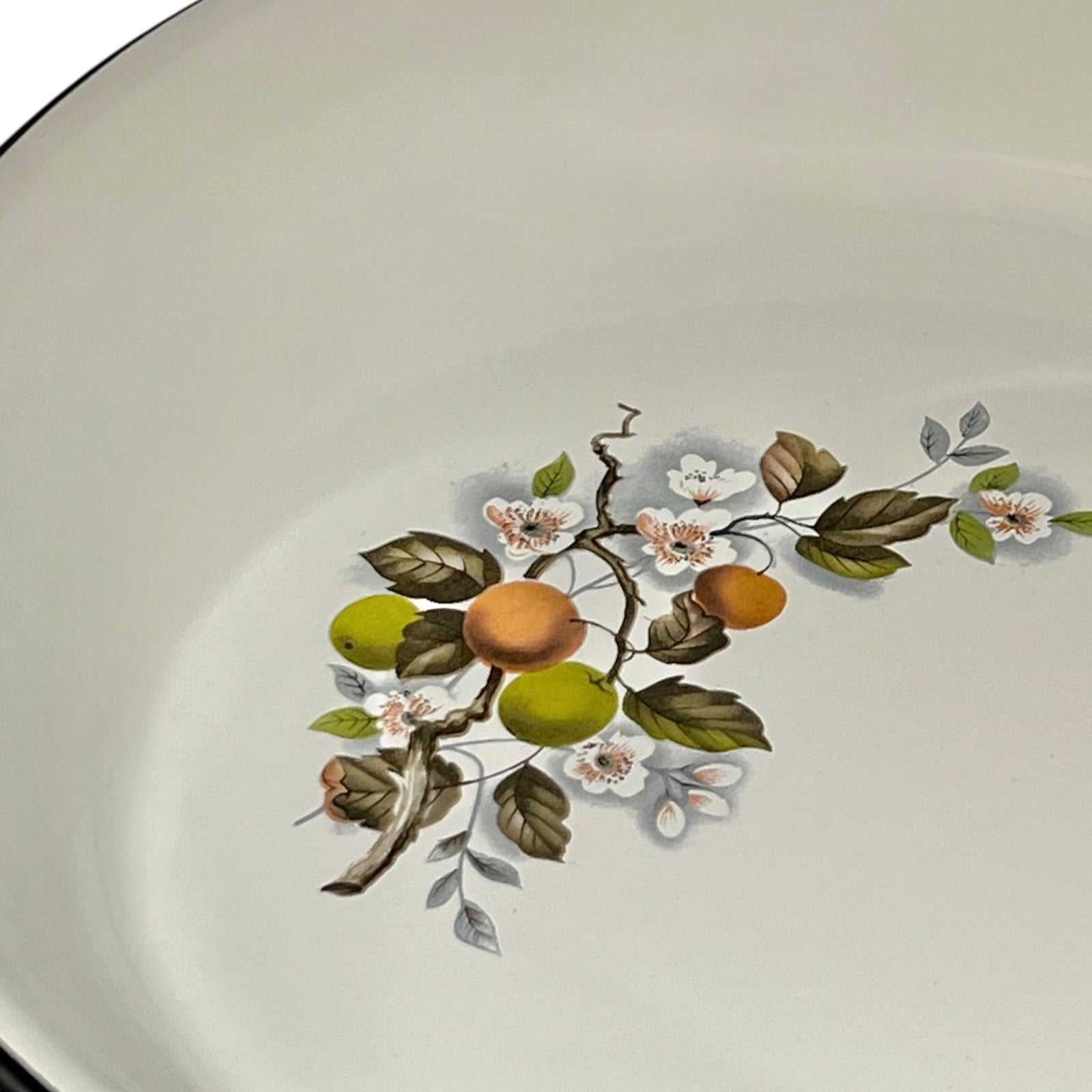 Decorative pattern with floral and fruit design in a frying pan on a white background
