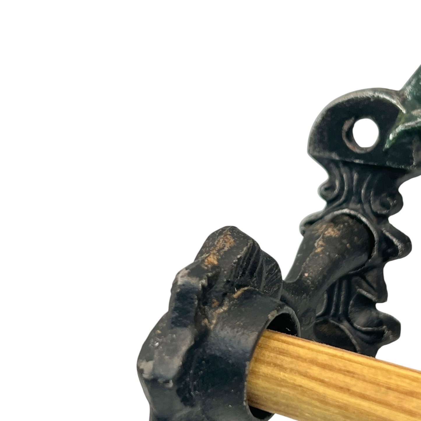 close up of a cast iron kitchen roll holder on a white background 