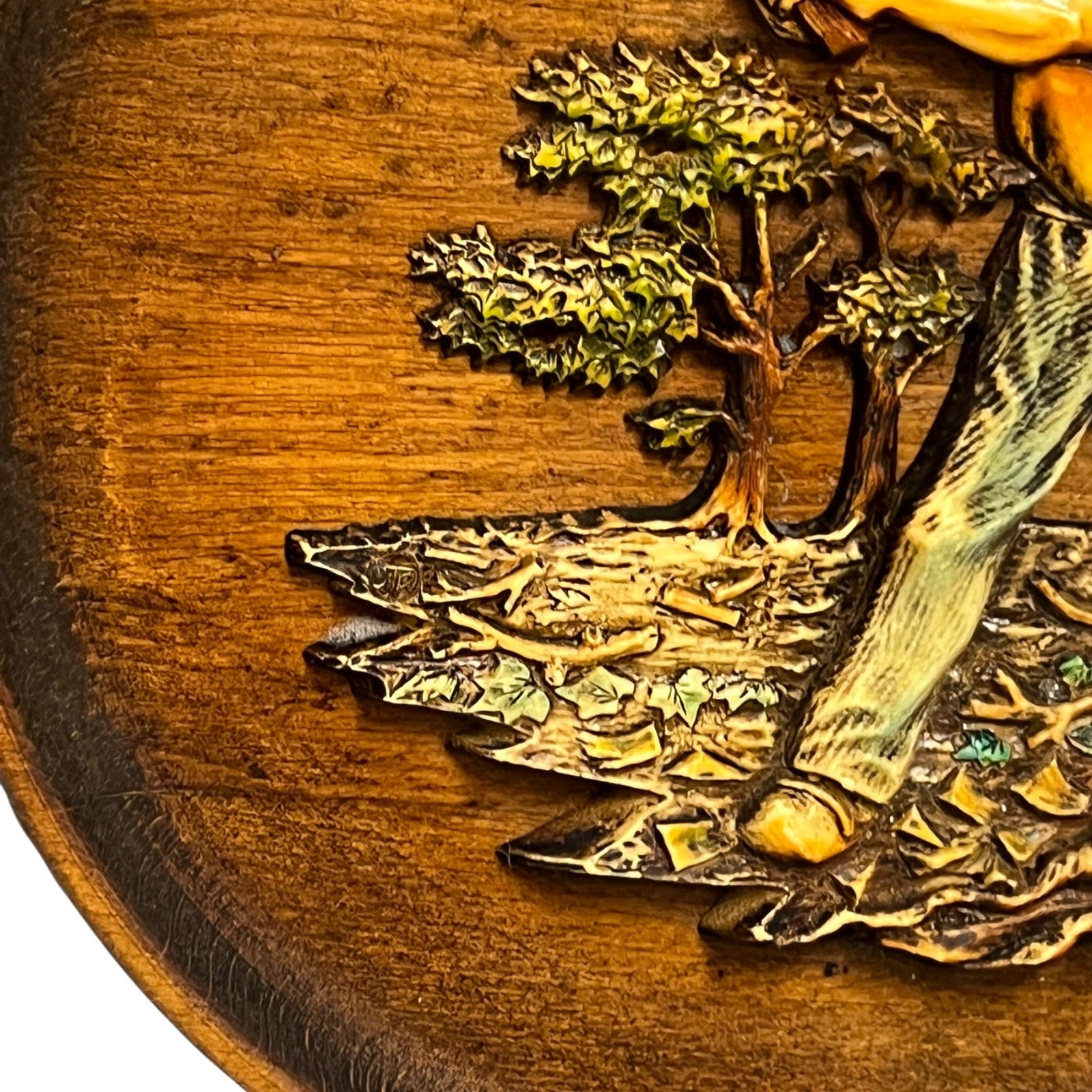 close up of a wooden decorative round plaque on a white background 