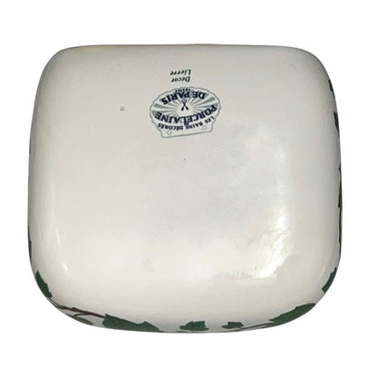 Porcelain bathroom soap dish  featuring green leaf patterns on a white background