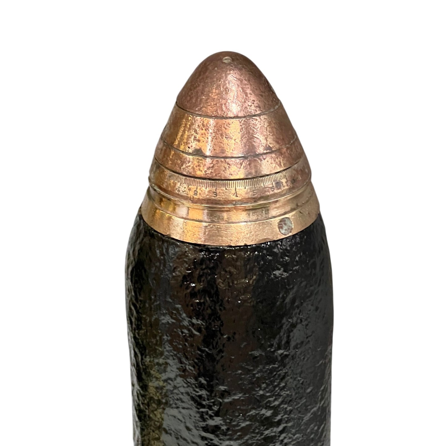 A close up of a WW1 18 pounder consisting of a brass shell, iron shrapnel and brass fuse on a white background 