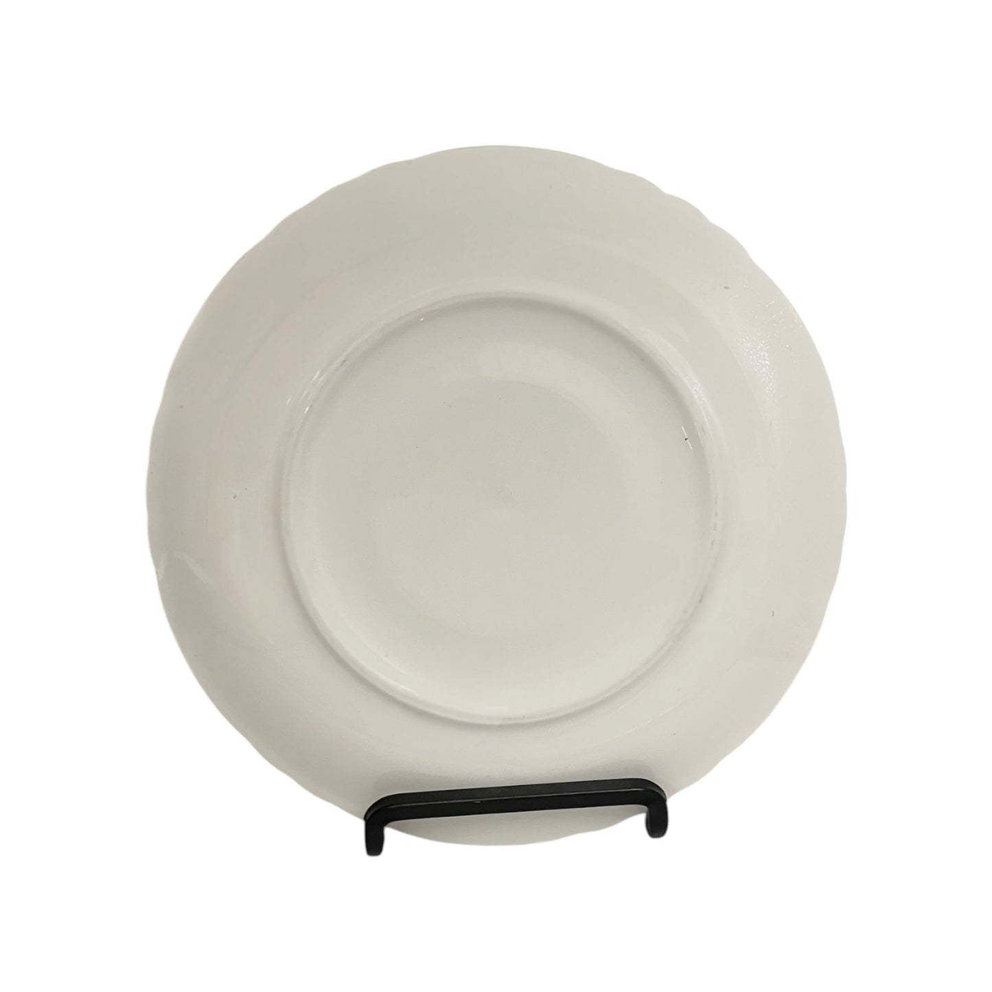White ceramic plate on a stand against a white background
