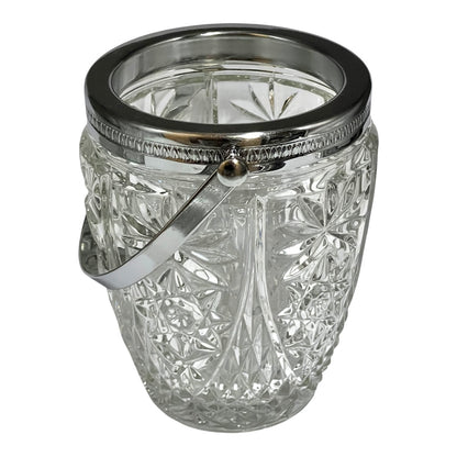 Decorative glass vintage ice bucket with metal collar and handle on a white background