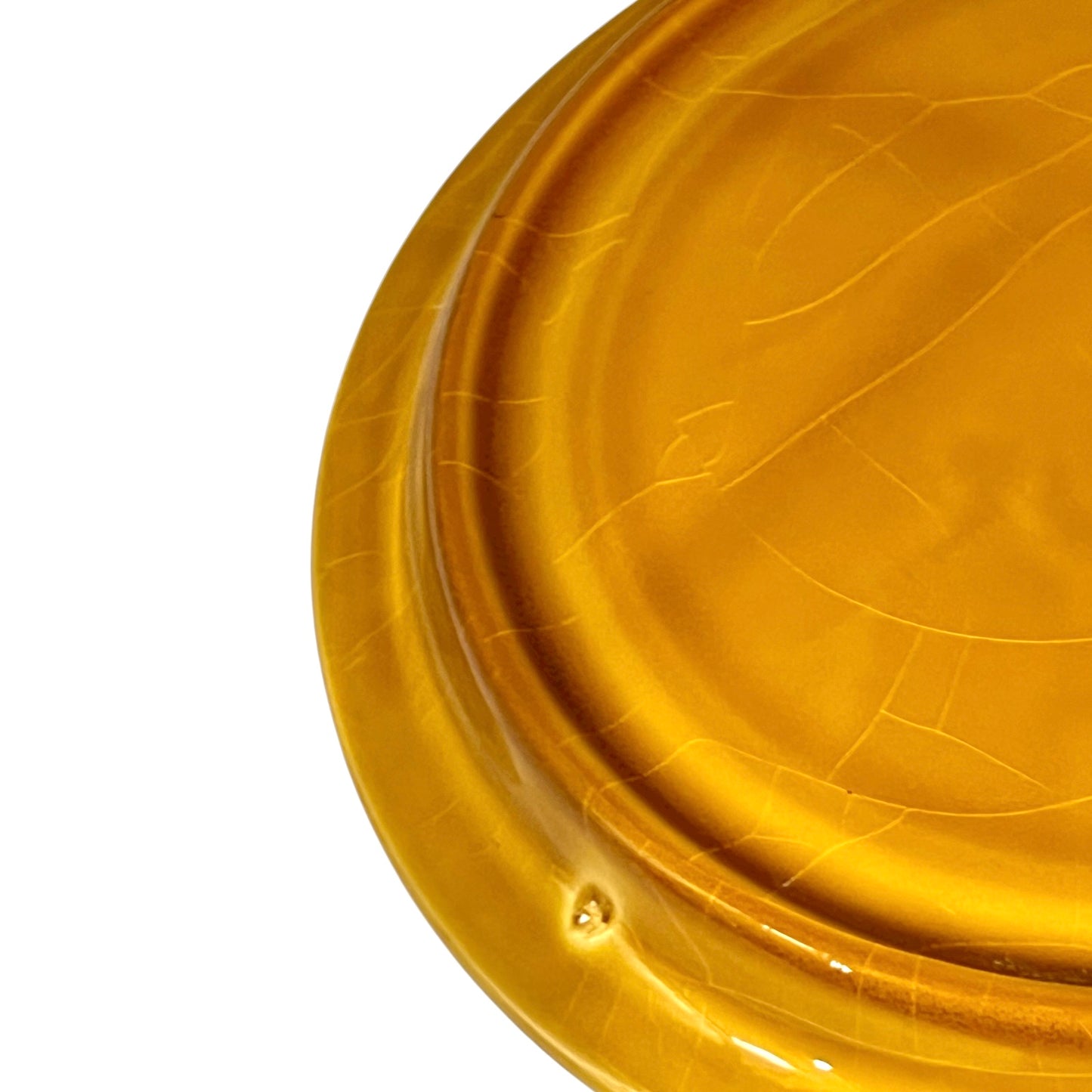 Back of fondue plate showing makers stamp on a white background