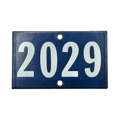 Blue and white vintage enamel door number 2029 on a white background 