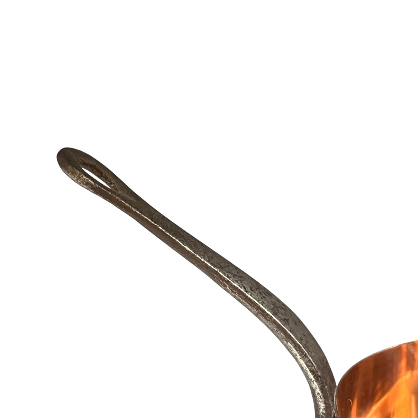 Close-up of a copper pot with a metal handle on a white background