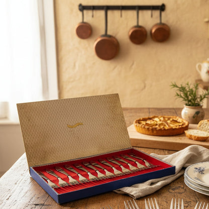 Set of silver forks in a decorative box with a red interior