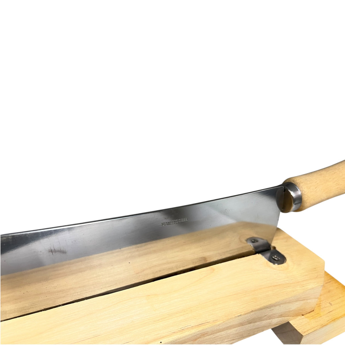 A Japanese-style kitchen knife with a long silver steel blade and a light natural wood handle, shown resting on a wooden block against a white background.
