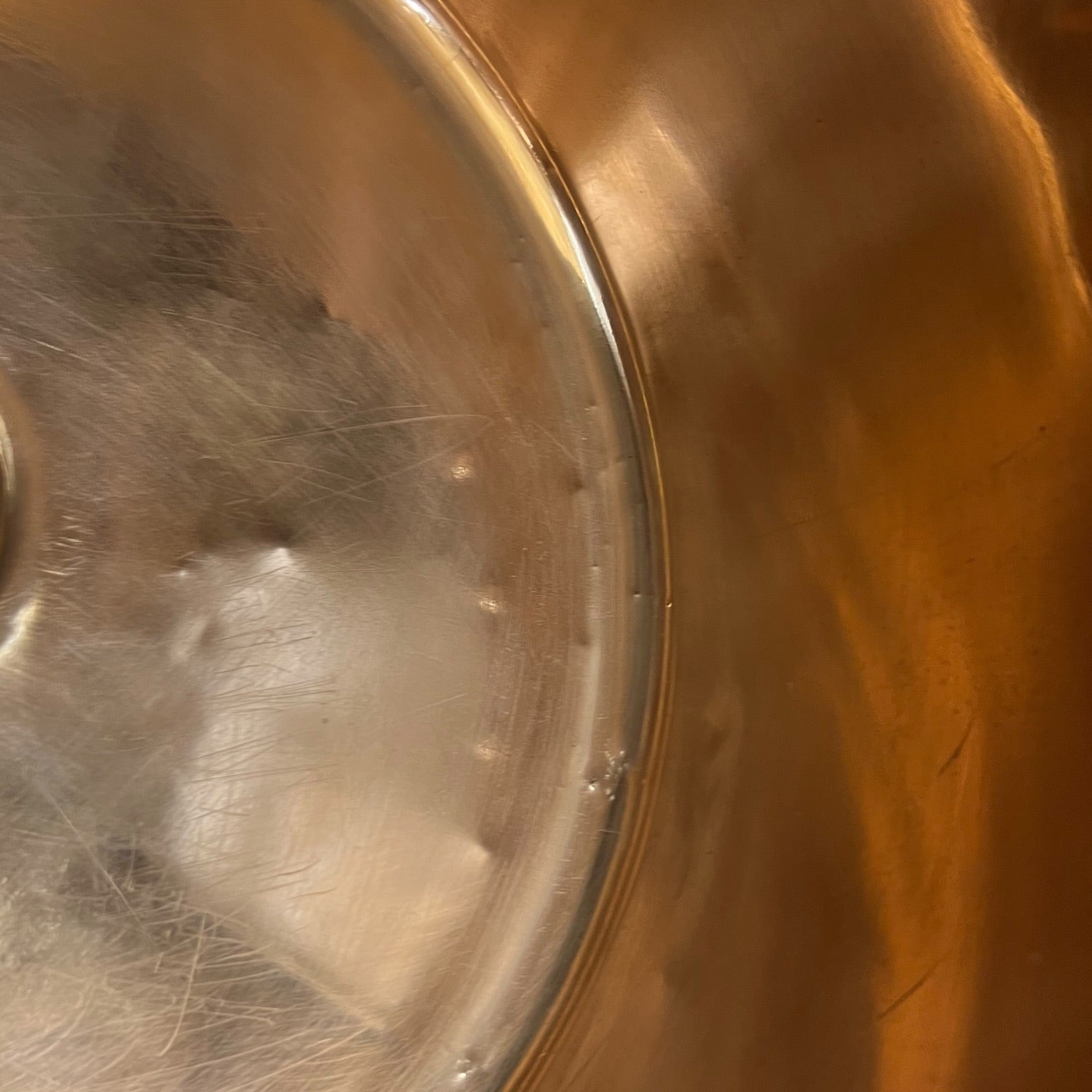 Close-up of the interior bottom of a copper sink.