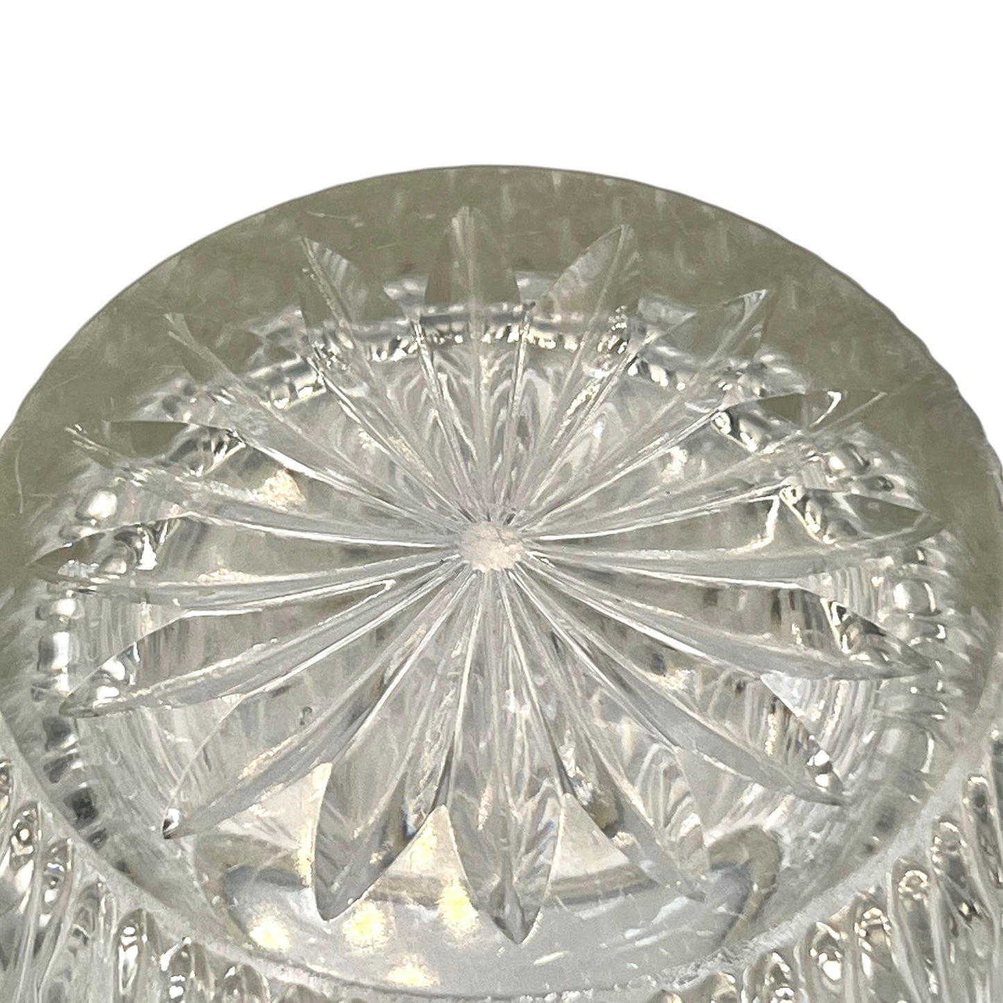 Close up of a French vintage glass ice bucket with a silver coloured collar and a handle on a white background 