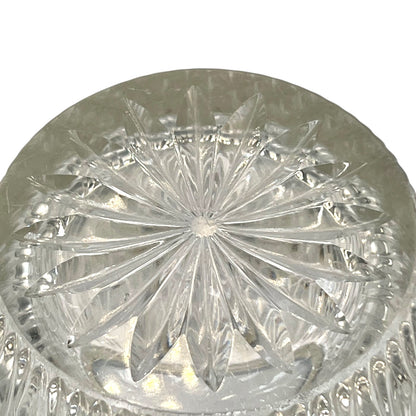 Close up of a French vintage glass ice bucket with a silver coloured collar and a handle on a white background 