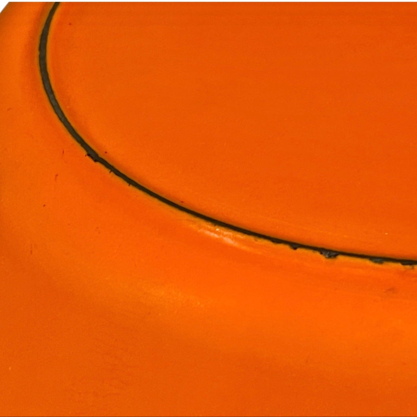 Le Creuset cast iron orange dish on a white background