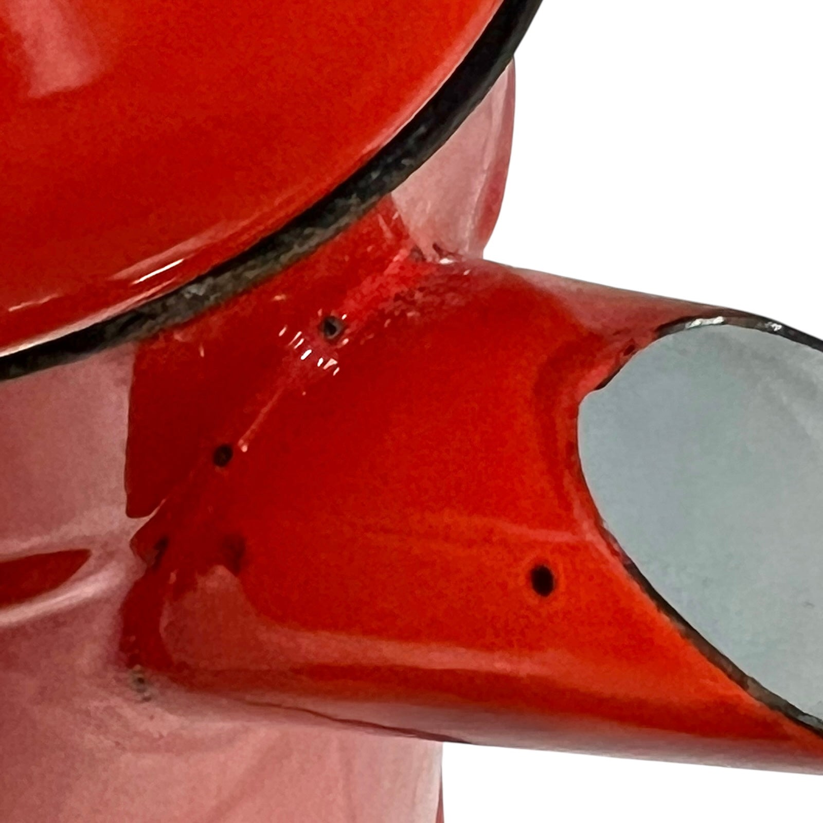 Close up of a red vintage French enamelled coffee pot on a white background